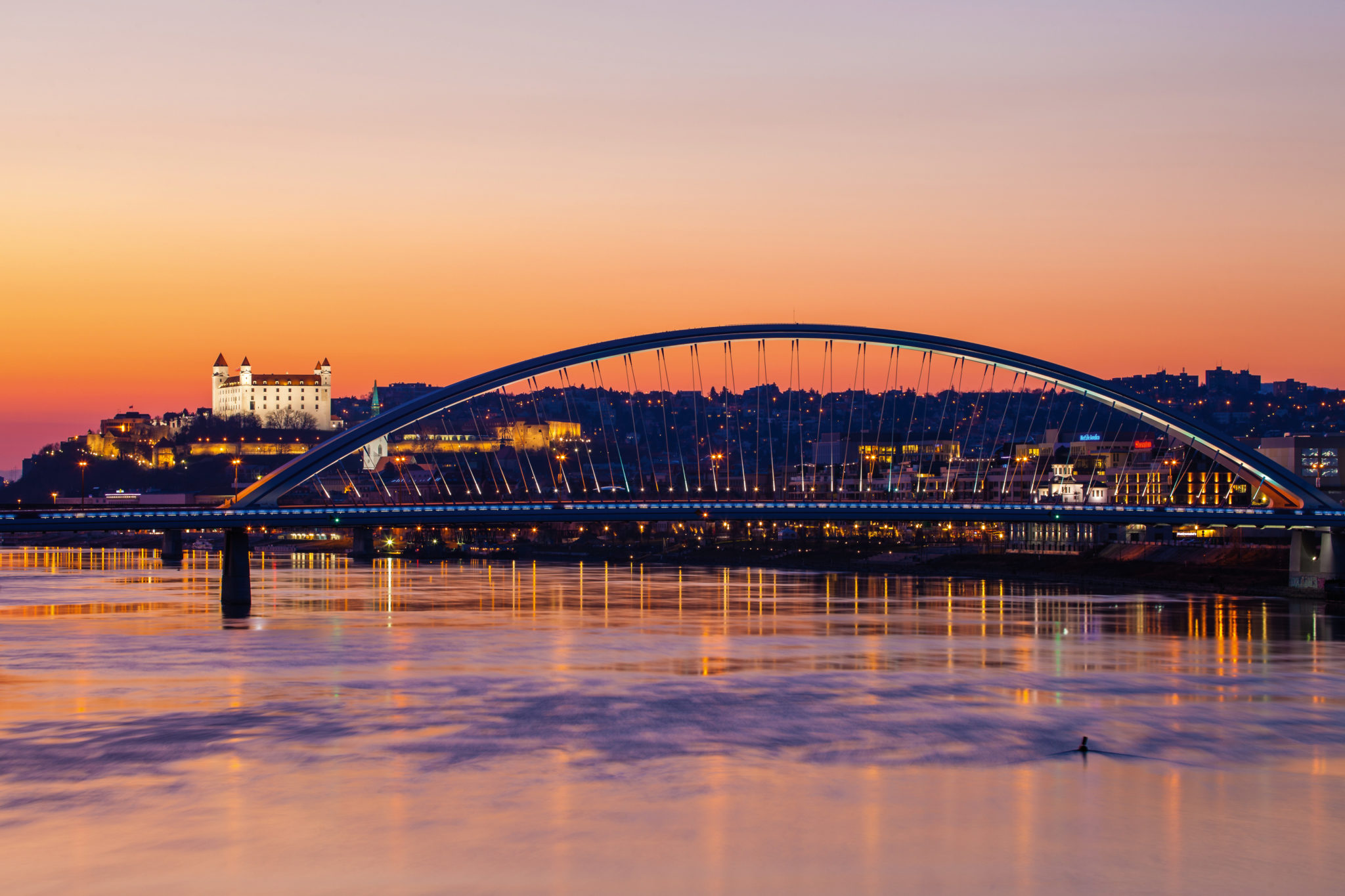 River Dunaj with bridge Apolo in sunset with Bratislava Castle.