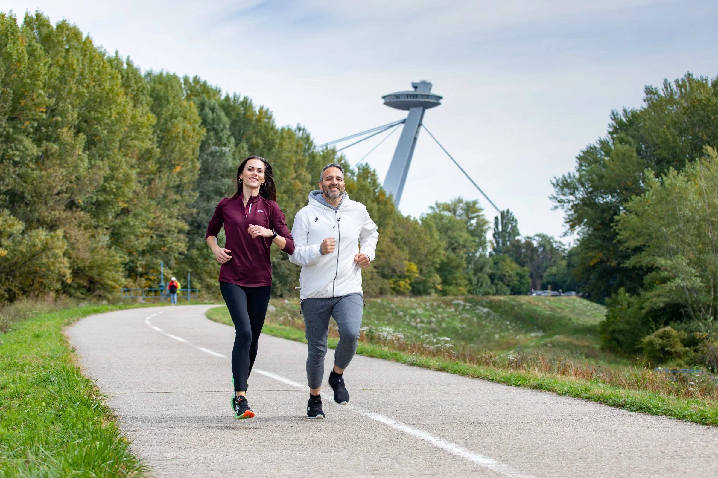 two runners with UFO behind